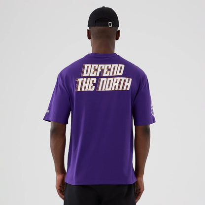 The Male model is wearing Minnesota Vikings NFL International Series Games 2025 Purple Oversized T-Shirt  2
