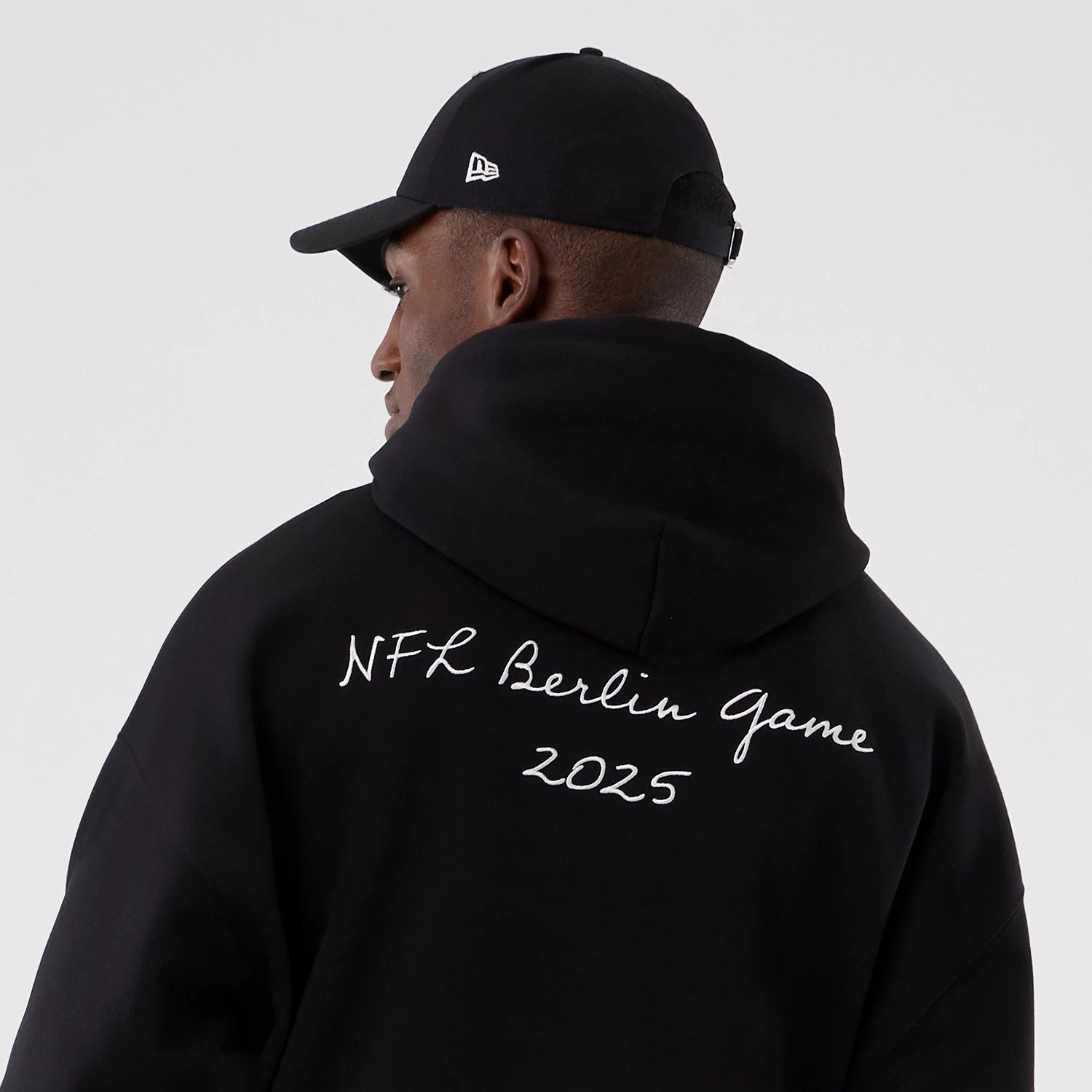 The Male model is wearing Atlanta Falcons NFL International Series Games 2025 Black Premium Pullover Hoodie 6