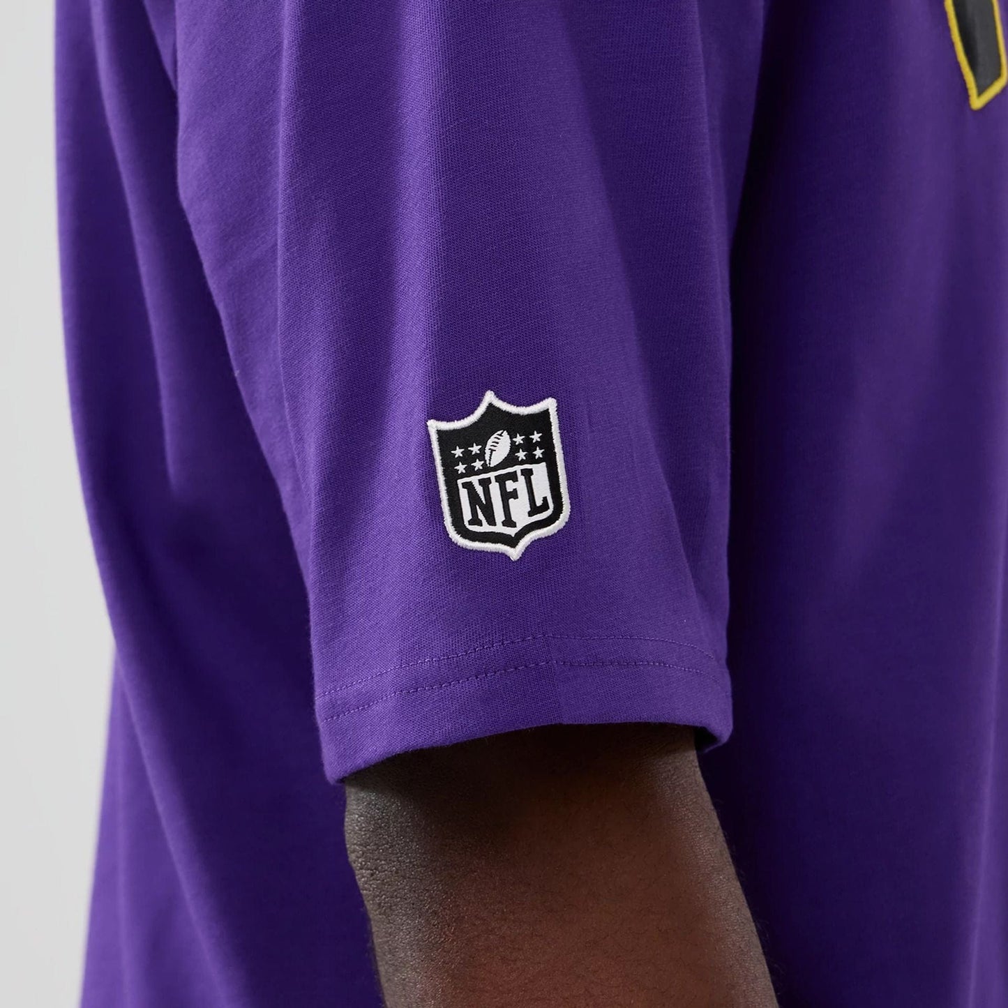 The Male model is wearing Minnesota Vikings NFL International Series Games 2025 Purple Premium T-Shirt  6