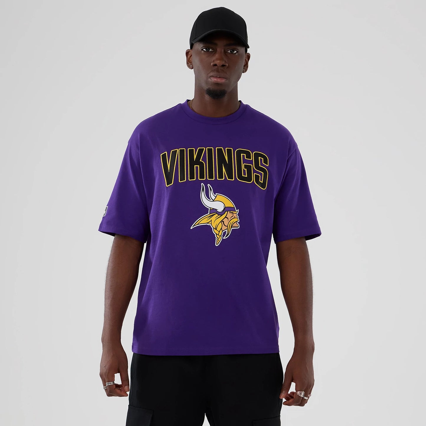 The Male model is wearing Minnesota Vikings NFL International Series Games 2025 Purple Premium T-Shirt 1