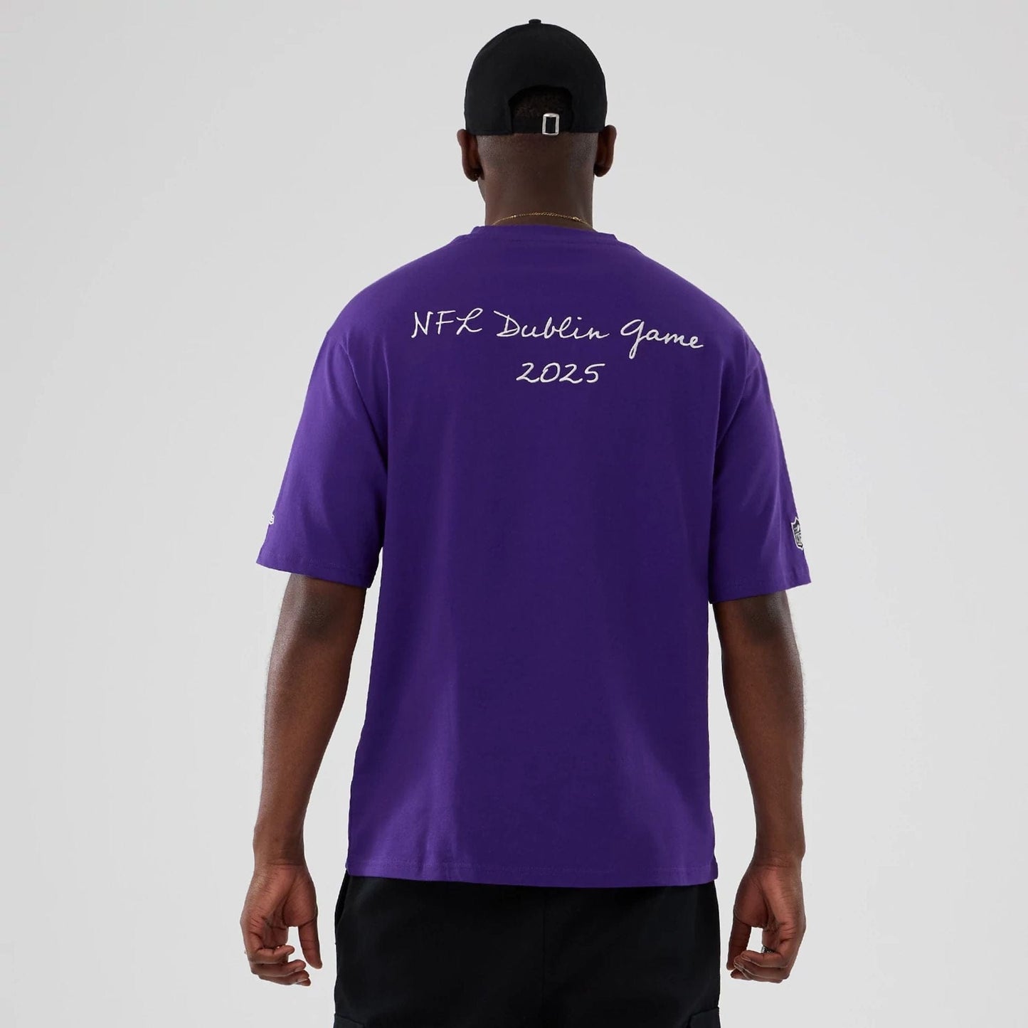 The Male model is wearing Minnesota Vikings NFL International Series Games 2025 Purple Premium T-Shirt  2