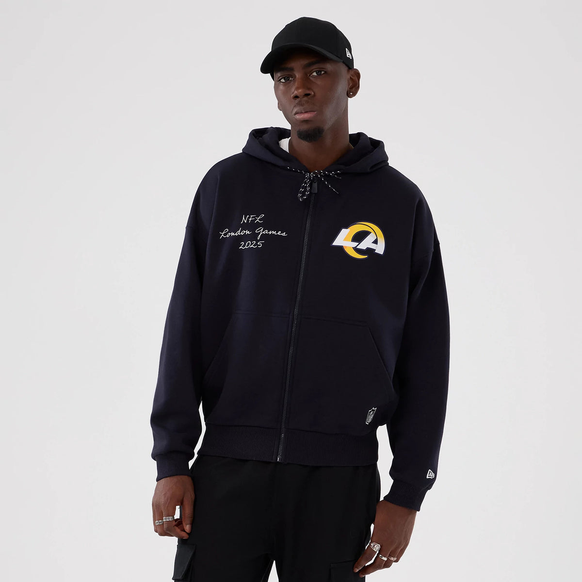 New Era LA Rams NFL International Series Games 2025 Navy Premium Pullover Hoodie, front view showing the LA Rams embroidered logo on the left chest, NFL London Games 2025 lettering on the right, and a New Era logo embroidered on the left cuff.