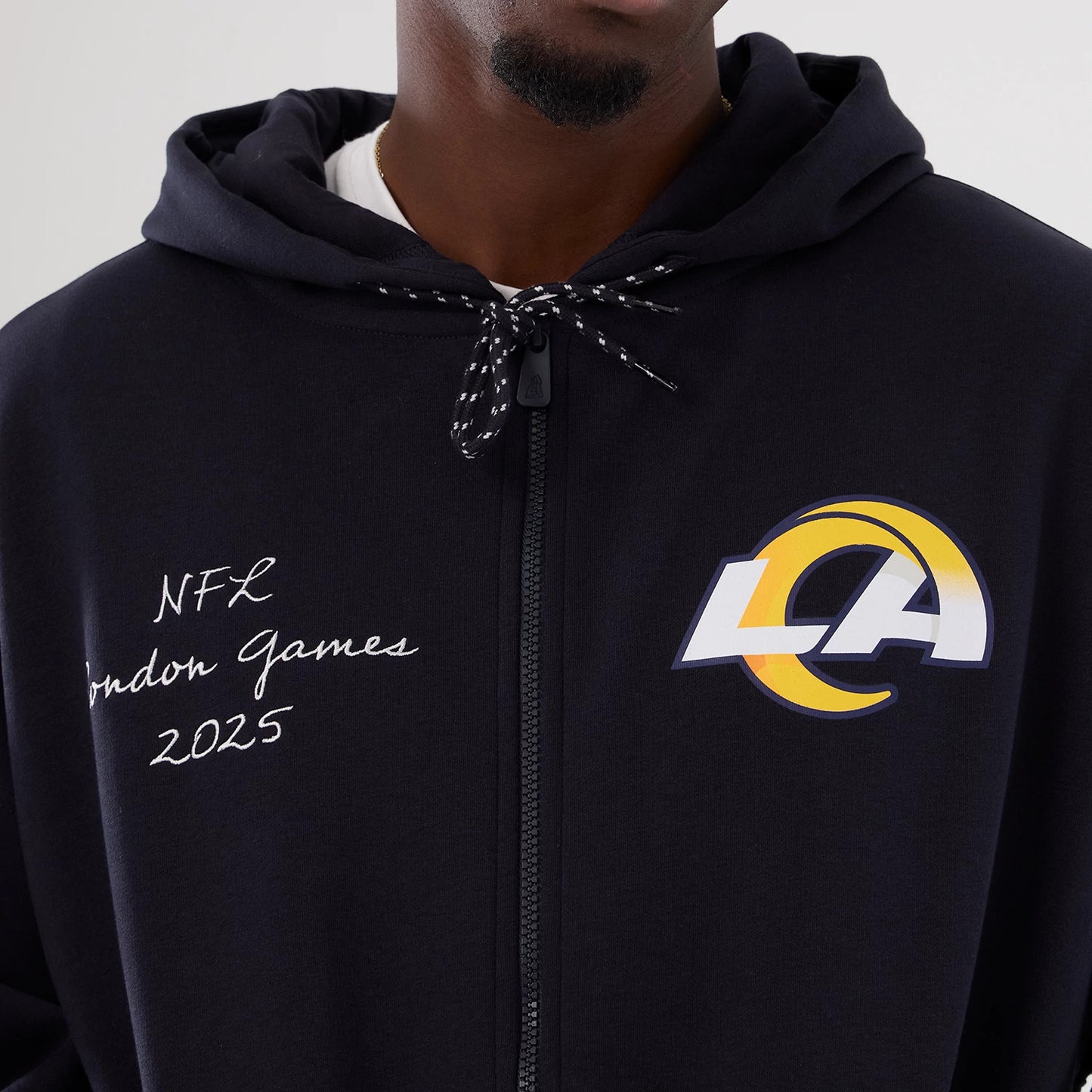 The Male model is wearing LA Rams NFL International Series Games 2025 Navy Premium Pullover Hoodie 6