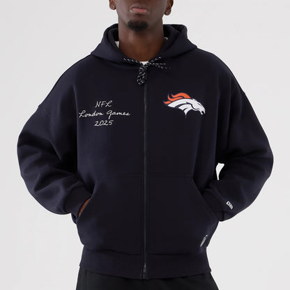New Era Denver Broncos NFL International Series Games 2025 Navy Premium Pullover Hoodie, front view on-model showing the embroidered Broncos logo on the left chest, NFL London Games 2025 script on the right chest.