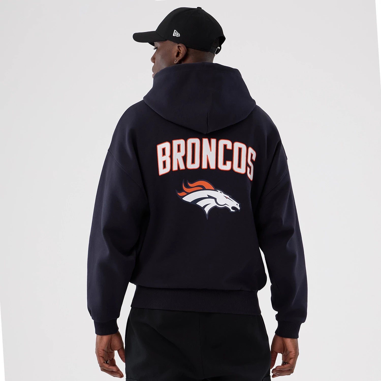 The Male model is wearing Denver Broncos NFL International Series Games 2025 Navy Premium Pullover Hoodie 2