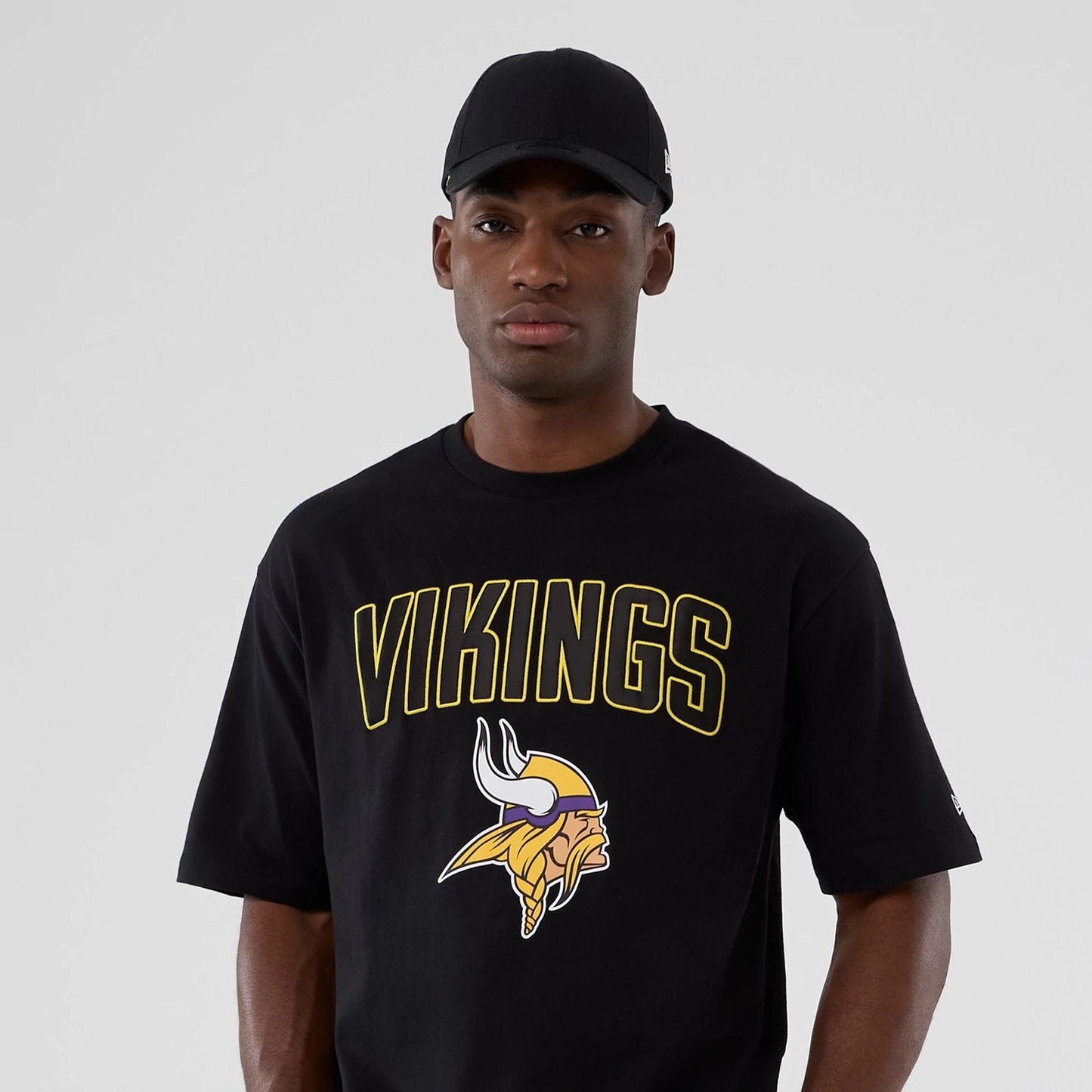 The Male model is wearing Minnesota Vikings NFL International Series Games 2025 Black Premium T-Shirt  7