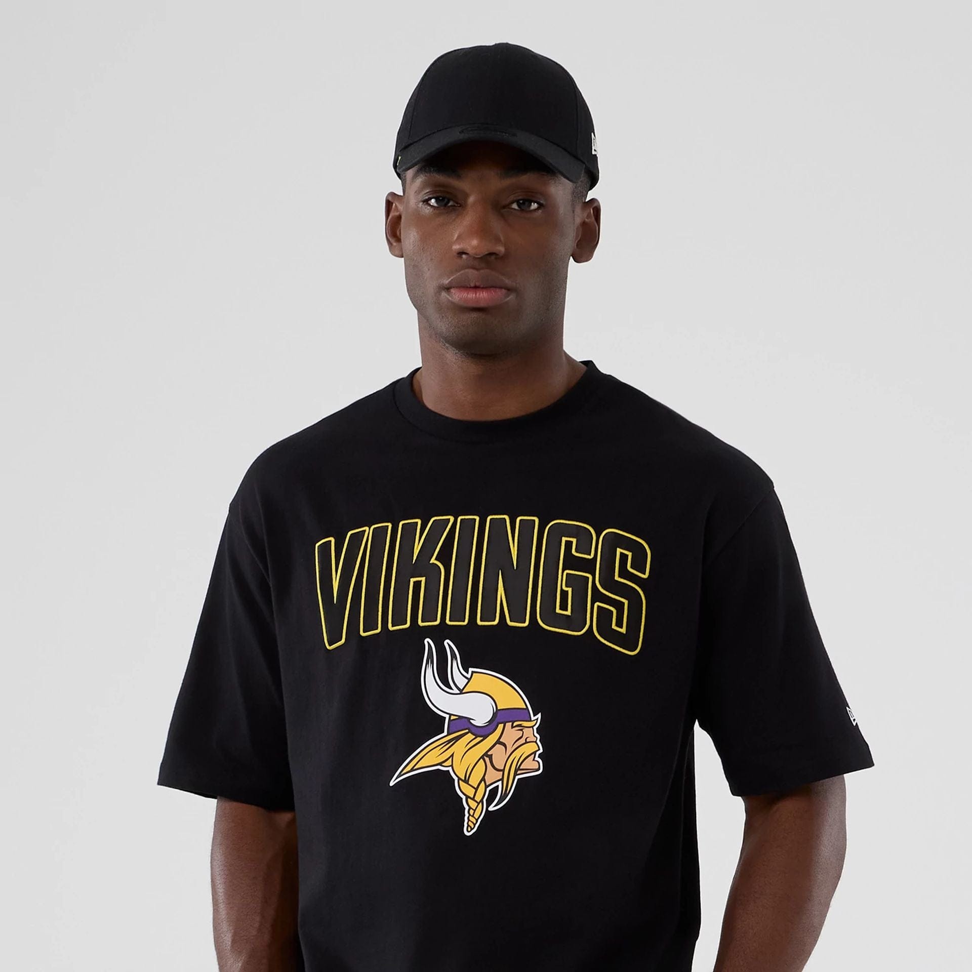 The Male model is wearing Minnesota Vikings NFL International Series Games 2025 Black Premium T-Shirt  7