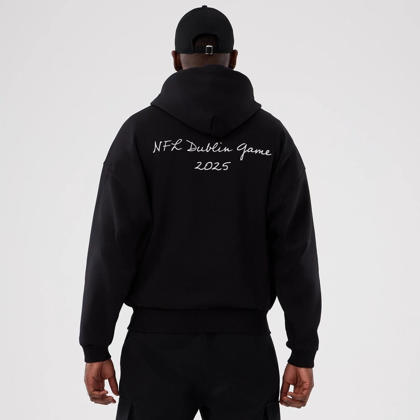 The Male model is wearing Minnesota Vikings NFL International Series Games 2025 Black Premium Pullover Hoodie  2