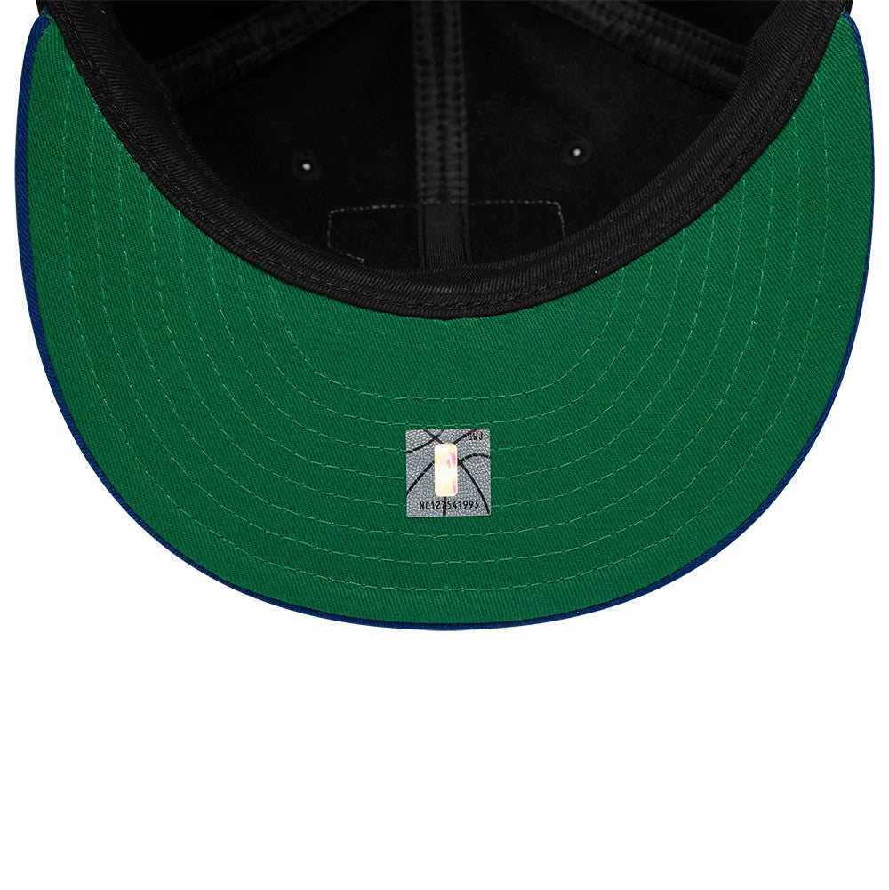 New York Knicks NBA Felt Logo Dark Blue Retro Crown New Era 59FIFTY Fitted Cap, inside view showing a green undervisor, black taping along the seams, and a 59FIFTY sticker centred near the front, with a black sweatband encircling the interior.