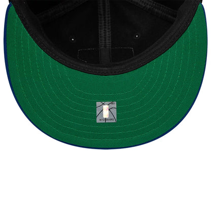 New York Knicks NBA Felt Logo Dark Blue Retro Crown New Era 59FIFTY Fitted Cap, inside view showing a green undervisor, black taping along the seams, and a 59FIFTY sticker centred near the front, with a black sweatband encircling the interior.