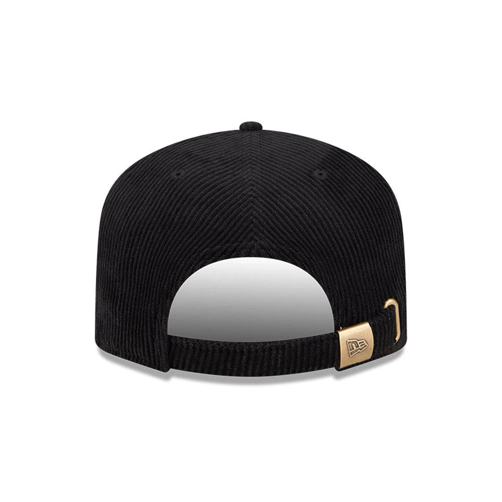 New Era Wide Cord Black 19TWENTY Adjustable Cap, rear view showing the fabric strap with a gold buckle and embroidered New Era flag logo, textured black corduroy crown, and curved opening at the back.
