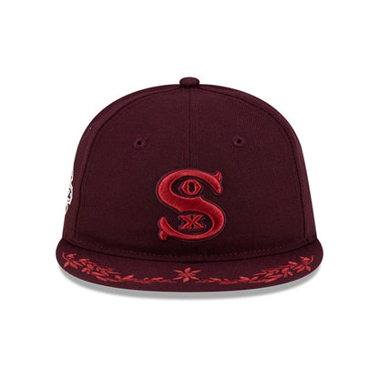 Chicago White Sox MLB Flourishes Purple Retro Crown New Era 9FIFTY Cap, front view showing a red embroidered 'Sox' logo on the centre of the purple crown, with red floral embroidery along the edge of the matching purple flat visor.