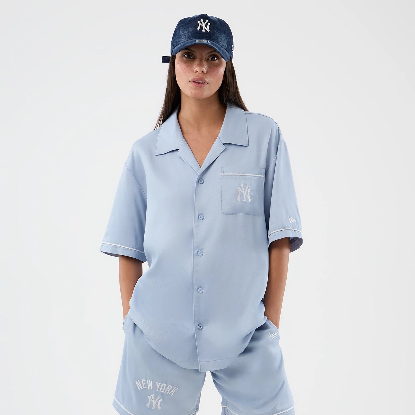 The model is wearing this MLB Graphic Revere New York Yankees Short Sleeve Shirt in pastel blue. 5
