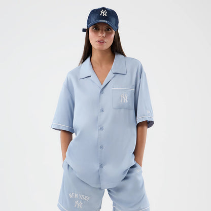 The model is wearing this MLB Graphic Revere New York Yankees Short Sleeve Shirt in pastel blue. 5