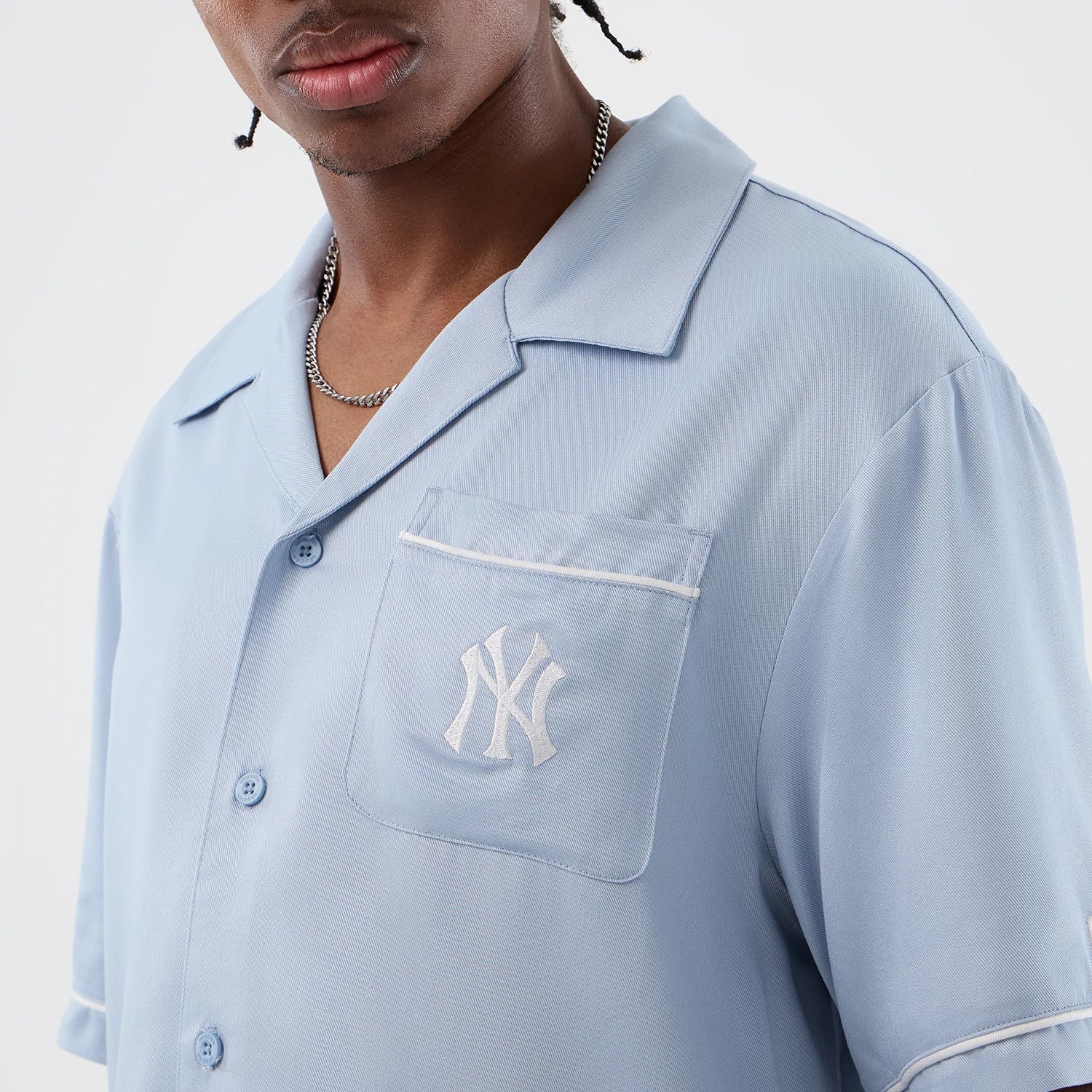 The model is wearing this MLB Graphic Revere New York Yankees Short Sleeve Shirt in pastel blue. 8