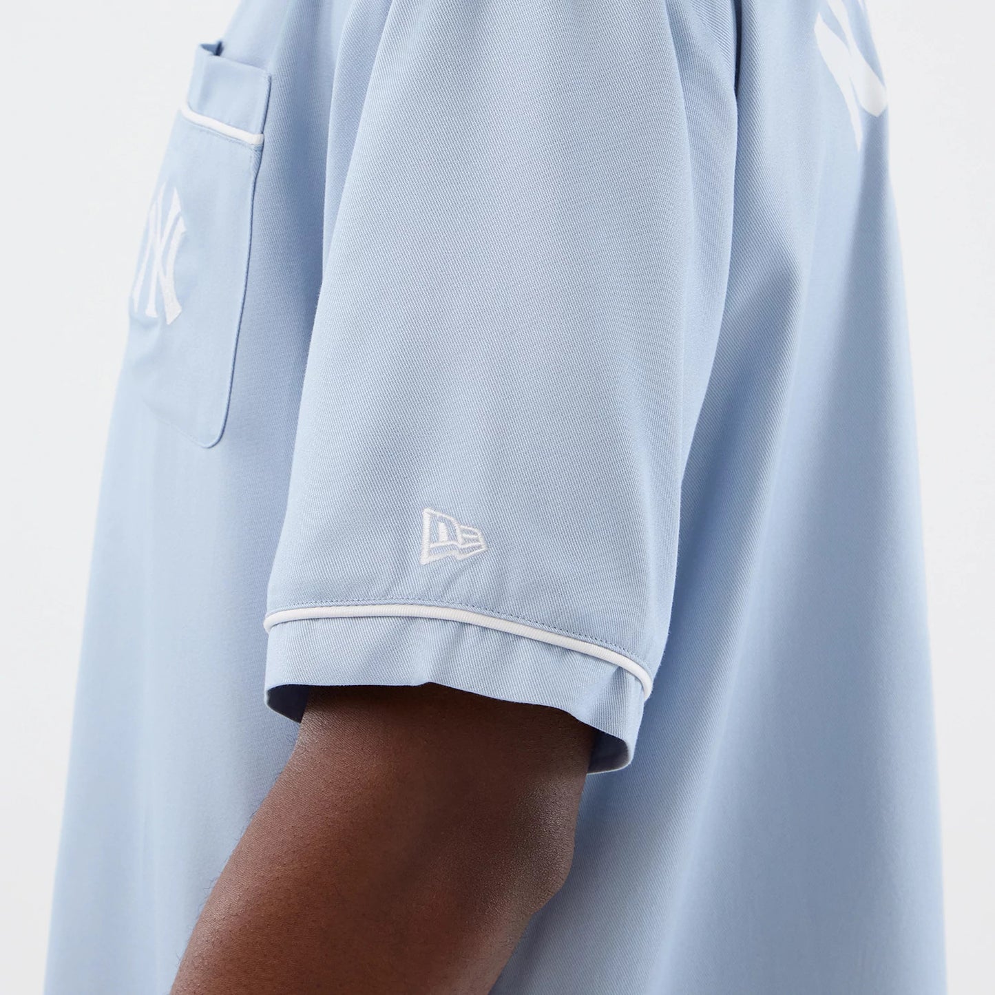 The model is wearing this MLB Graphic Revere New York Yankees Short Sleeve Shirt in pastel blue. 7