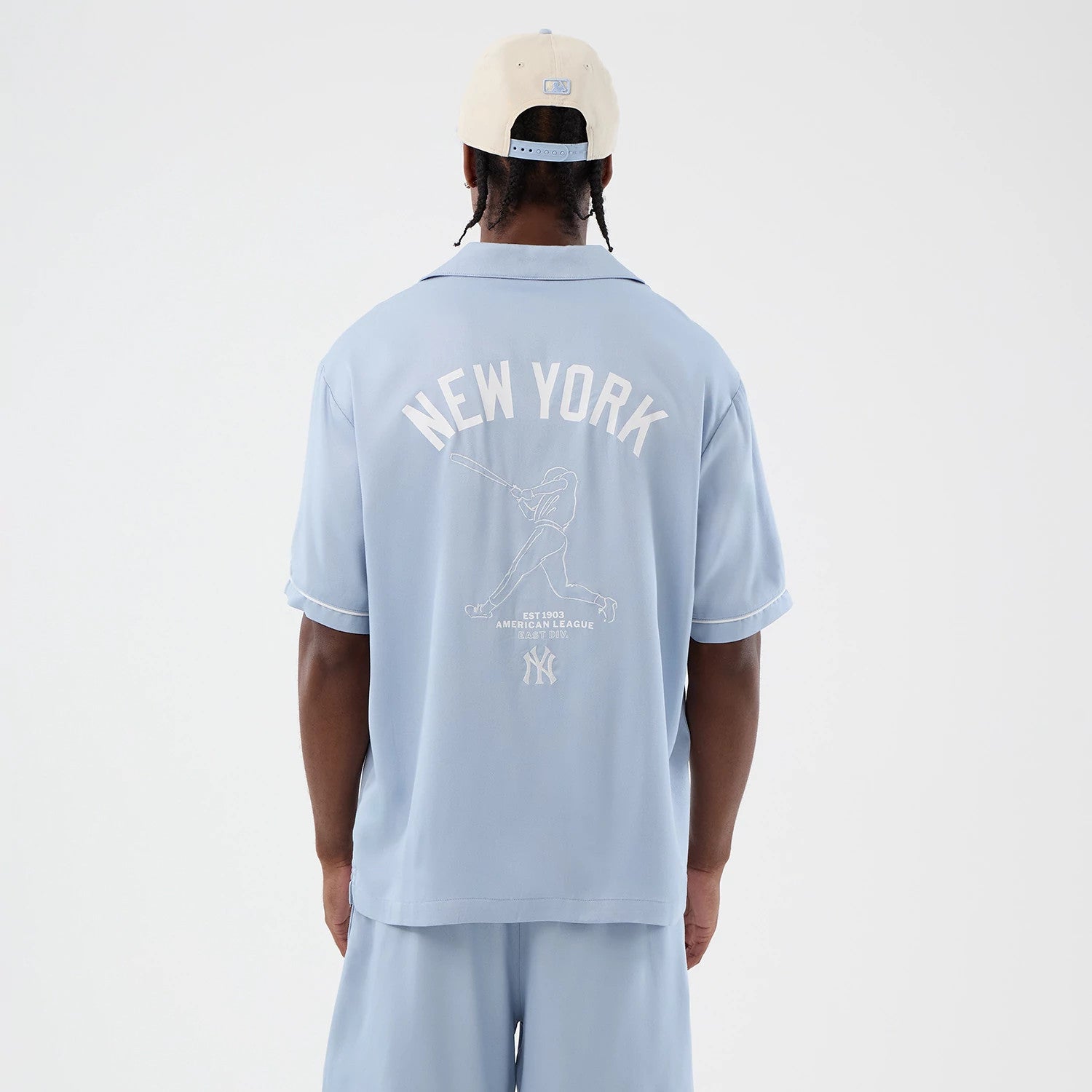 The model is wearing this MLB Graphic Revere New York Yankees Short Sleeve Shirt in pastel blue. 2