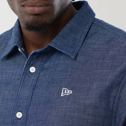 The model is wearing this New Era Denim Short Sleeve Shirt in blue. 4