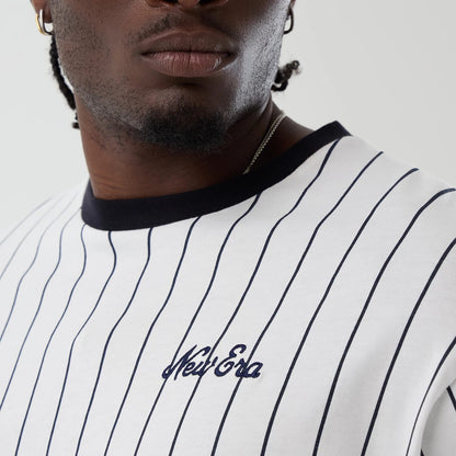 The model is wearing this New Era Pinstripe Oversized T-Shirt in Open White. 3