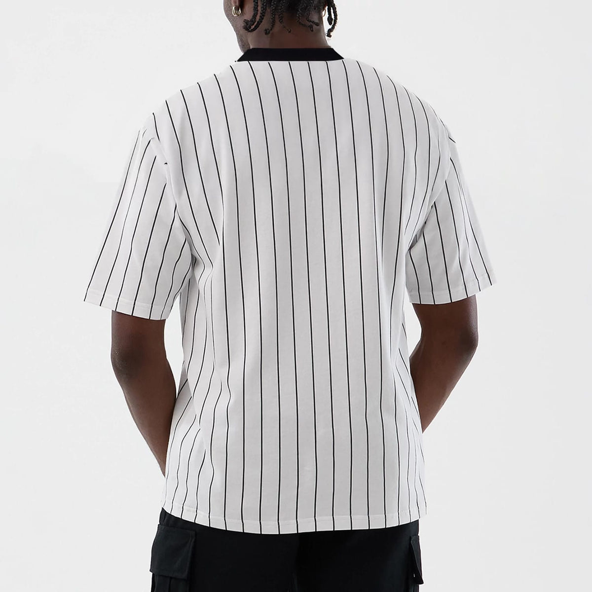 The model is wearing this New Era Pinstripe Oversized T-Shirt in Open White. 2