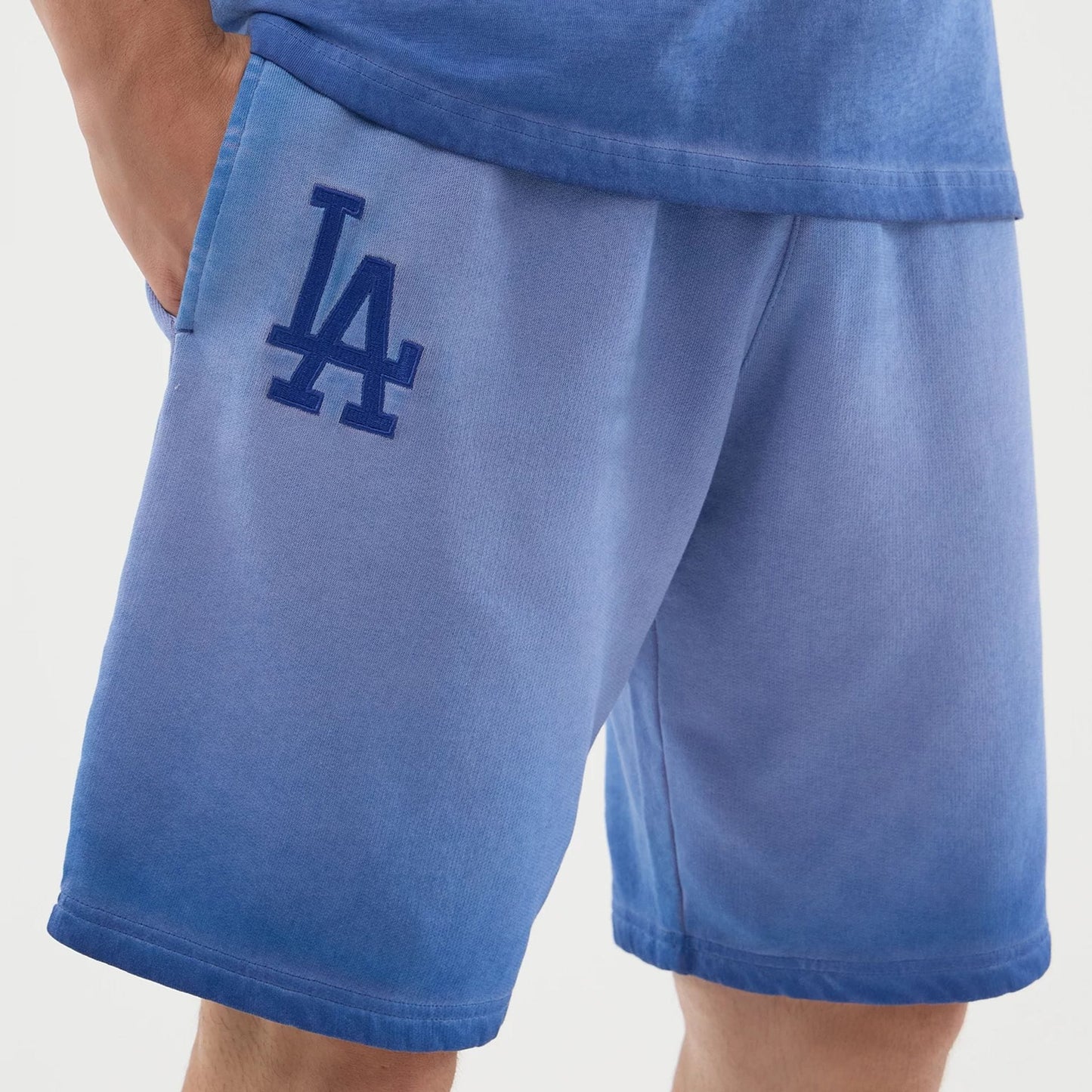The model is wearing this MLB Washed Logo LA Dodgers Shorts in pastel blue. 4