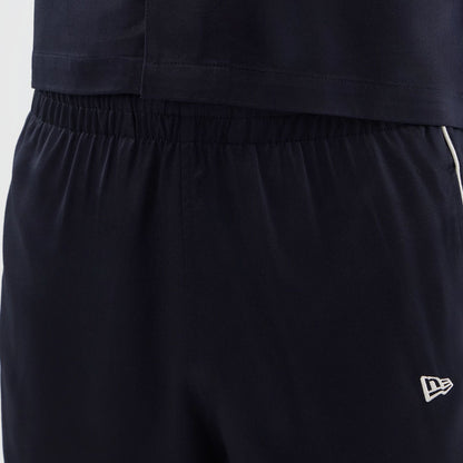 The model is wearing this New Era Piping Shorts in navy. 5