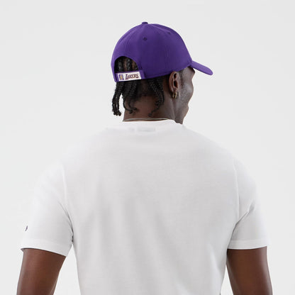 The model is wearing this NBA Graphic LA Lakers T-Shirt in white. 7