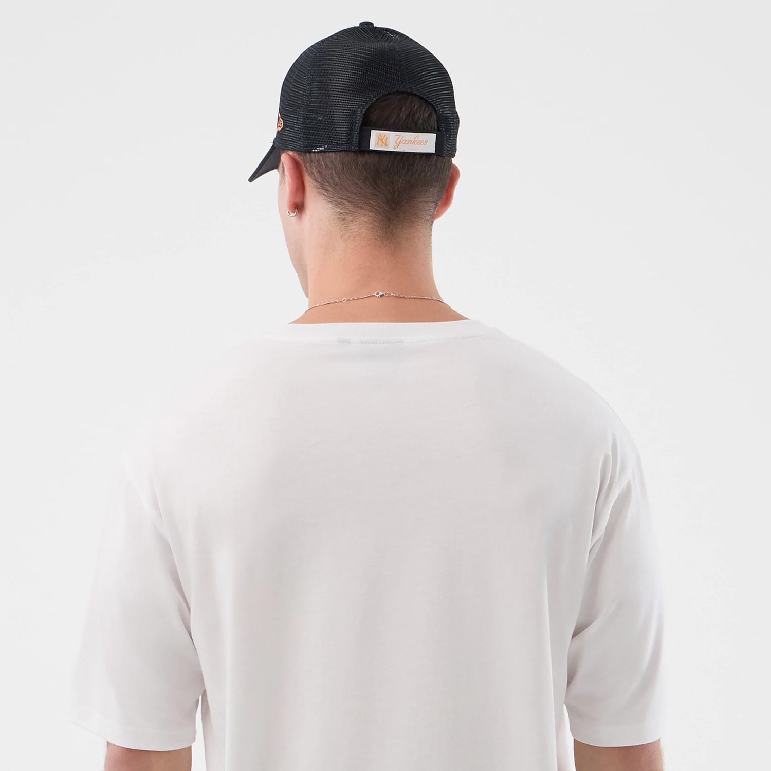 The model is wearing this New Era Death Moth Graphic Oversized T-Shirt in white. 7