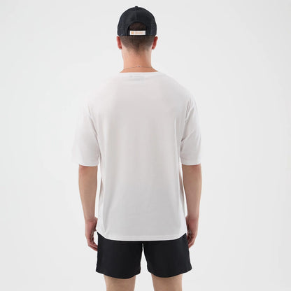 The model is wearing this New Era Death Moth Graphic Oversized T-Shirt in white. 2