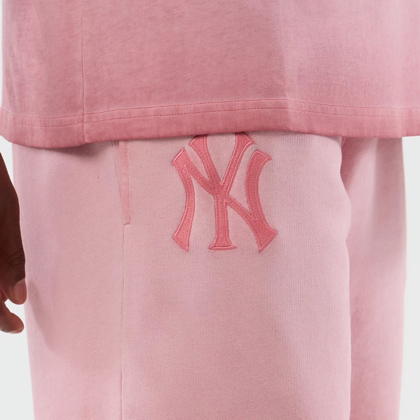 The model is wearing this MLB Washed Logo New York Yankees Shorts in pastel pink. 3