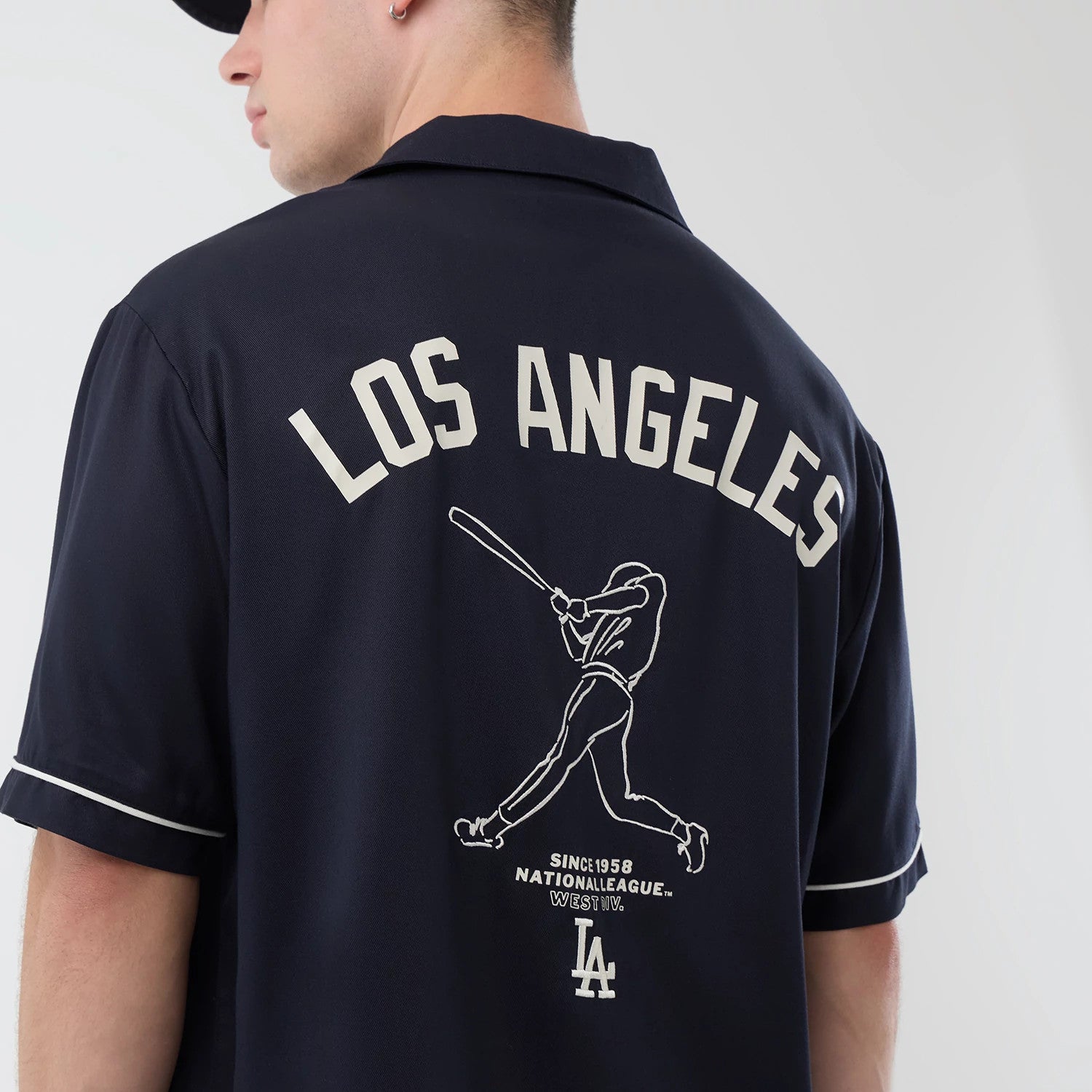 The model is wearing this MLB Graphic Revere LA Dodgers Short Sleeve Shirt in navy. 4