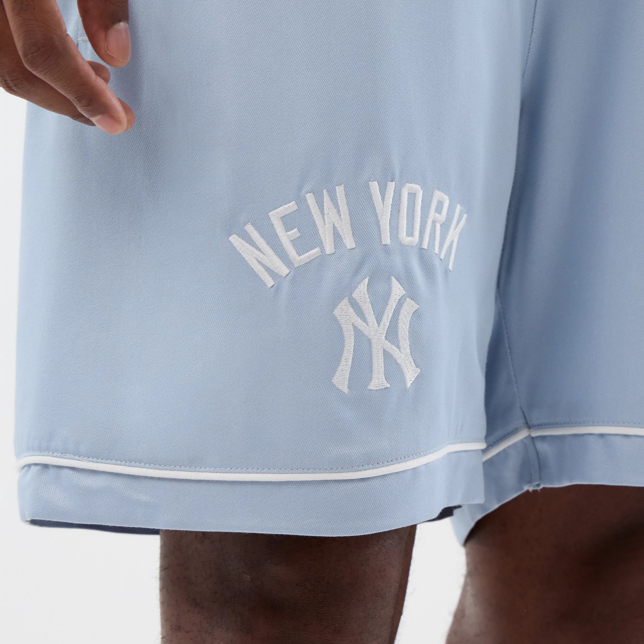 The model is wearing this MLB Woven New York Yankees Shorts in pastel blue. 4