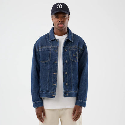 The model is wearing this New Era Script Denim Jacket in dark blue. 3