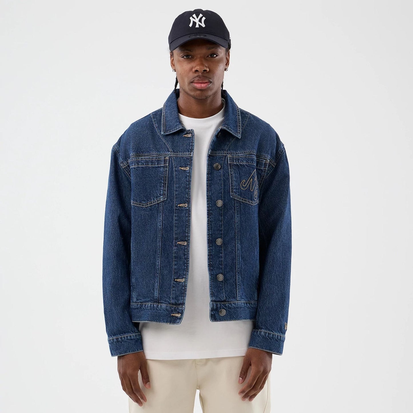 The model is wearing this New Era Script Denim Jacket in dark blue. 3