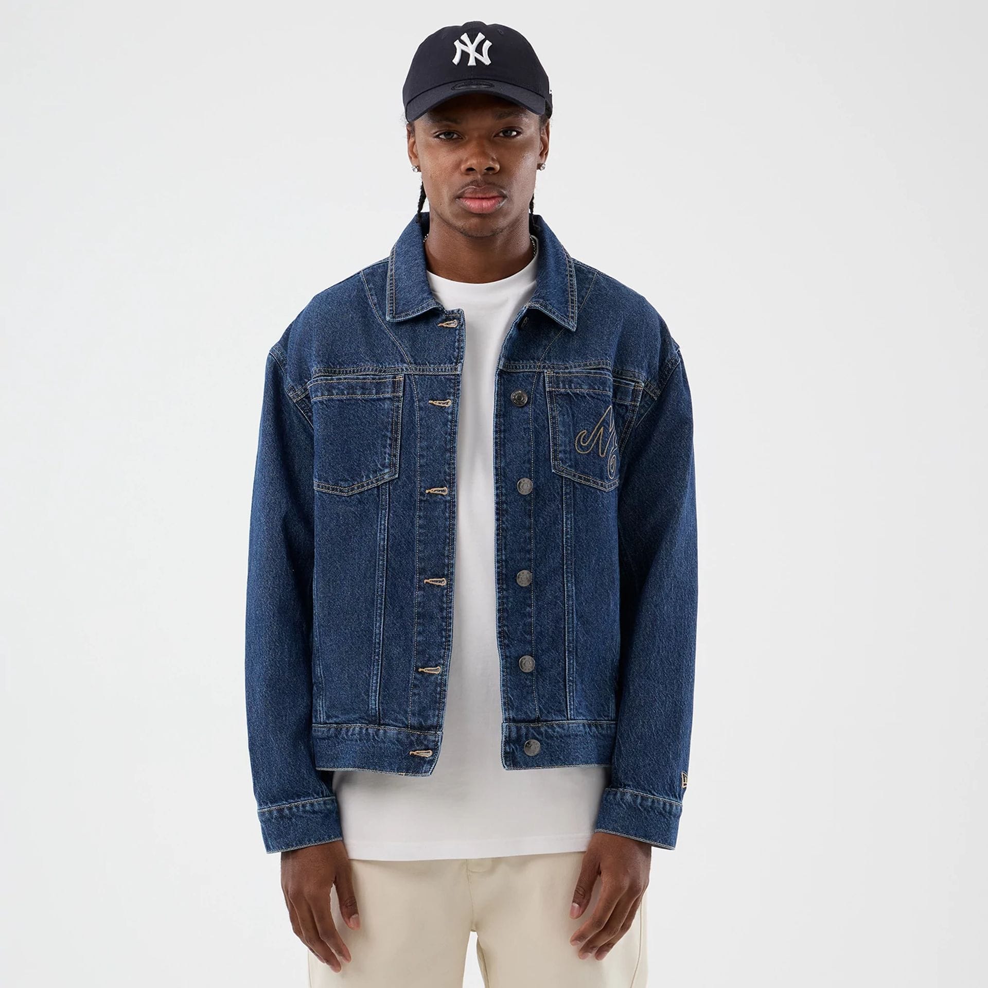 The model is wearing this New Era Script Denim Jacket in dark blue. 3