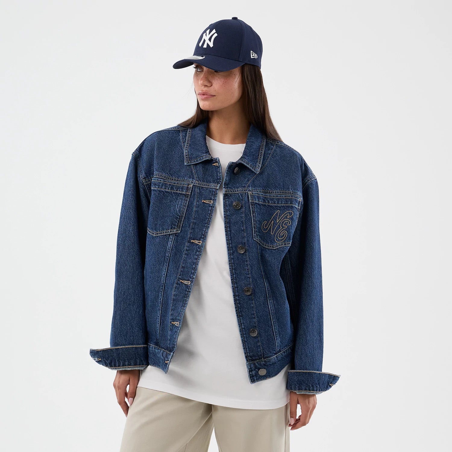 The model is wearing this New Era Script Denim Jacket in dark blue. 4