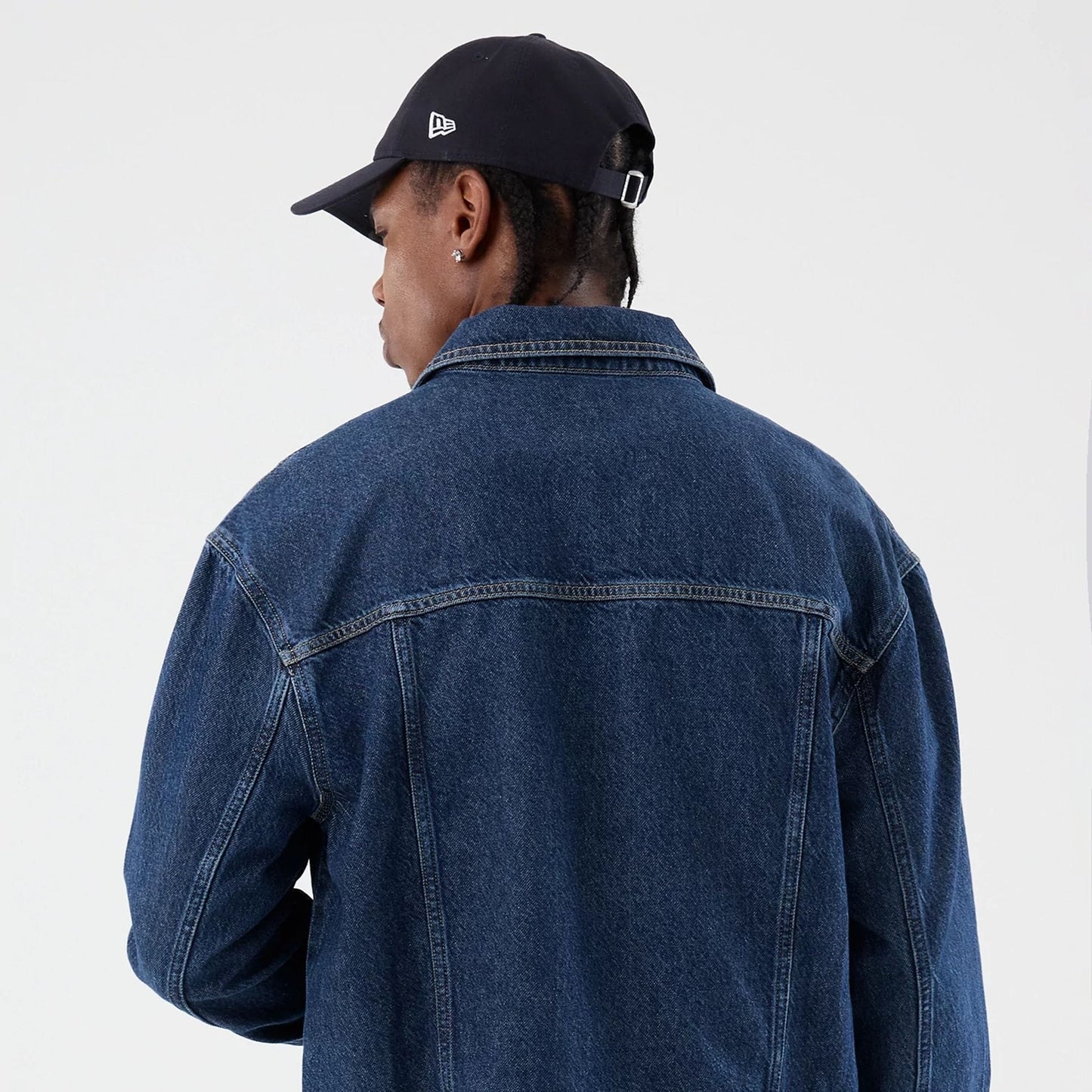 The model is wearing this New Era Script Denim Jacket in dark blue. 8