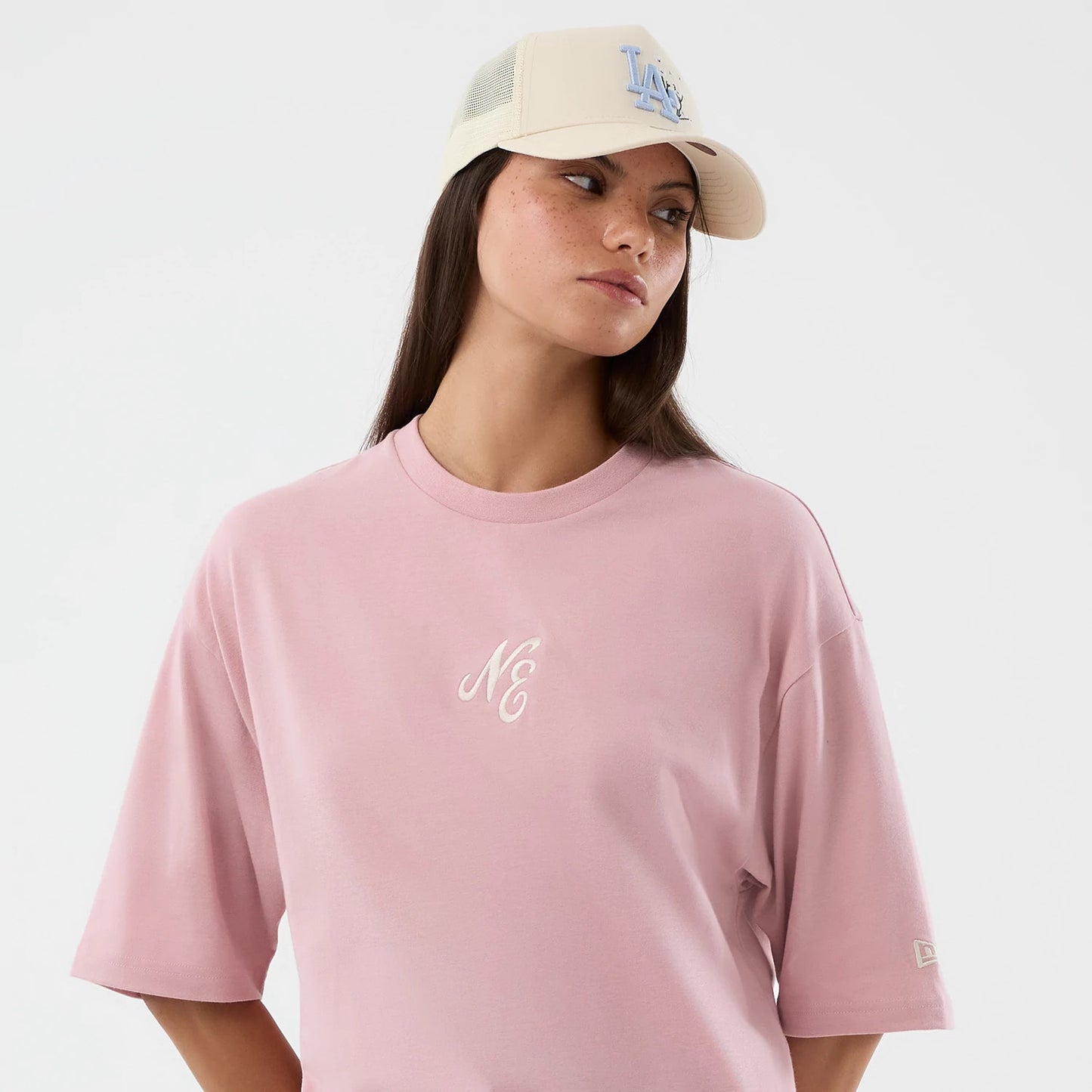 The model is wearing this New Era Floral Graphic Oversized T-Shirt in pastel pink. 6