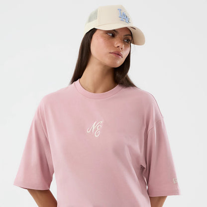 The model is wearing this New Era Floral Graphic Oversized T-Shirt in pastel pink. 6
