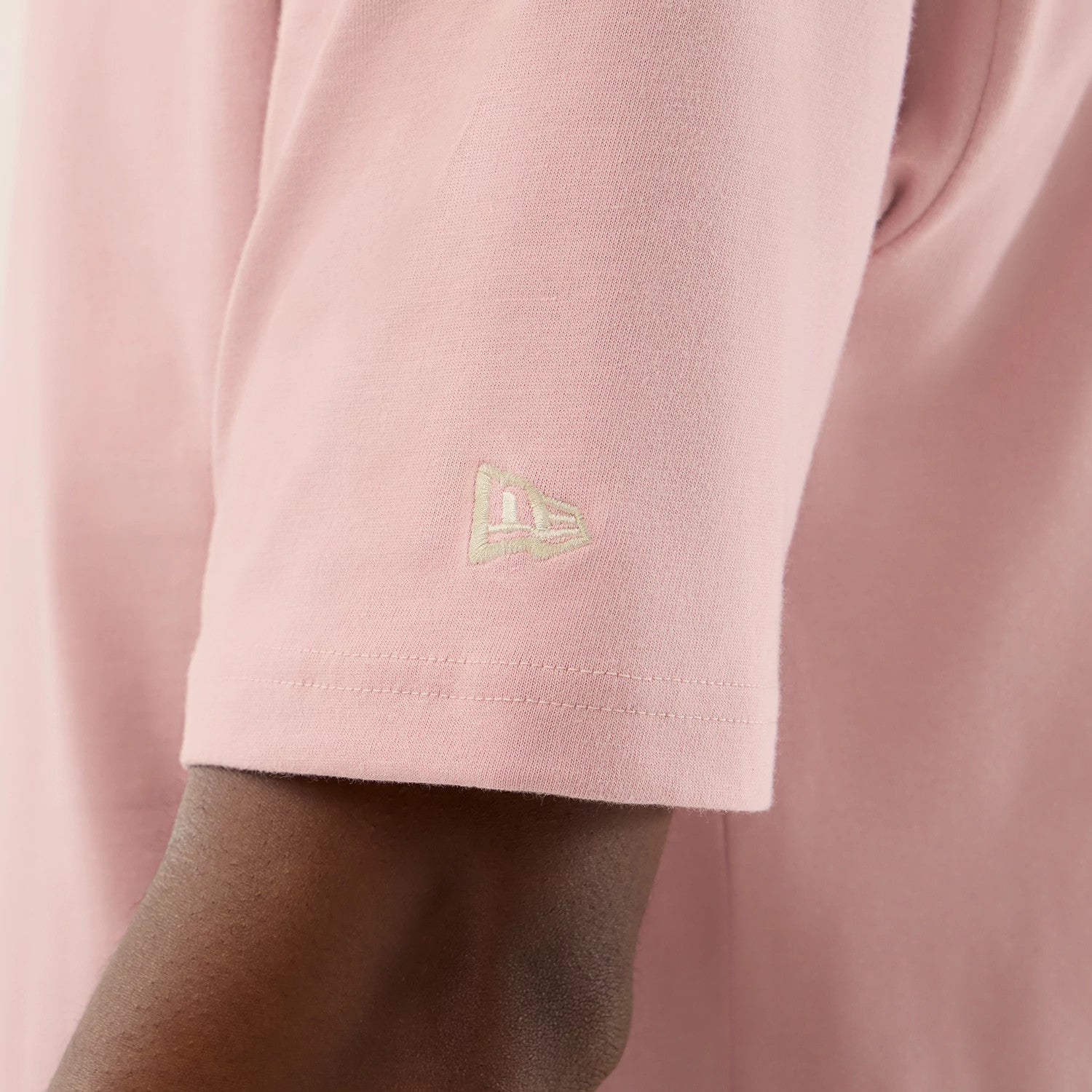 The model is wearing this New Era Floral Graphic Oversized T-Shirt in pastel pink. 7