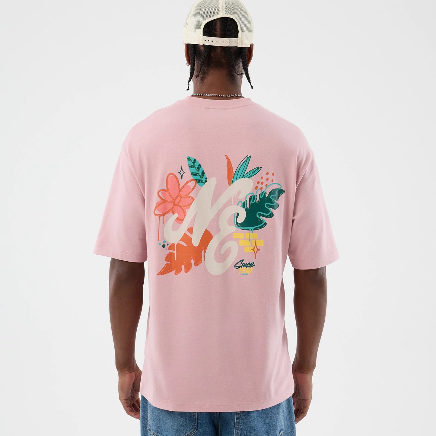 The model is wearing this New Era Floral Graphic Oversized T-Shirt in pastel pink. 3