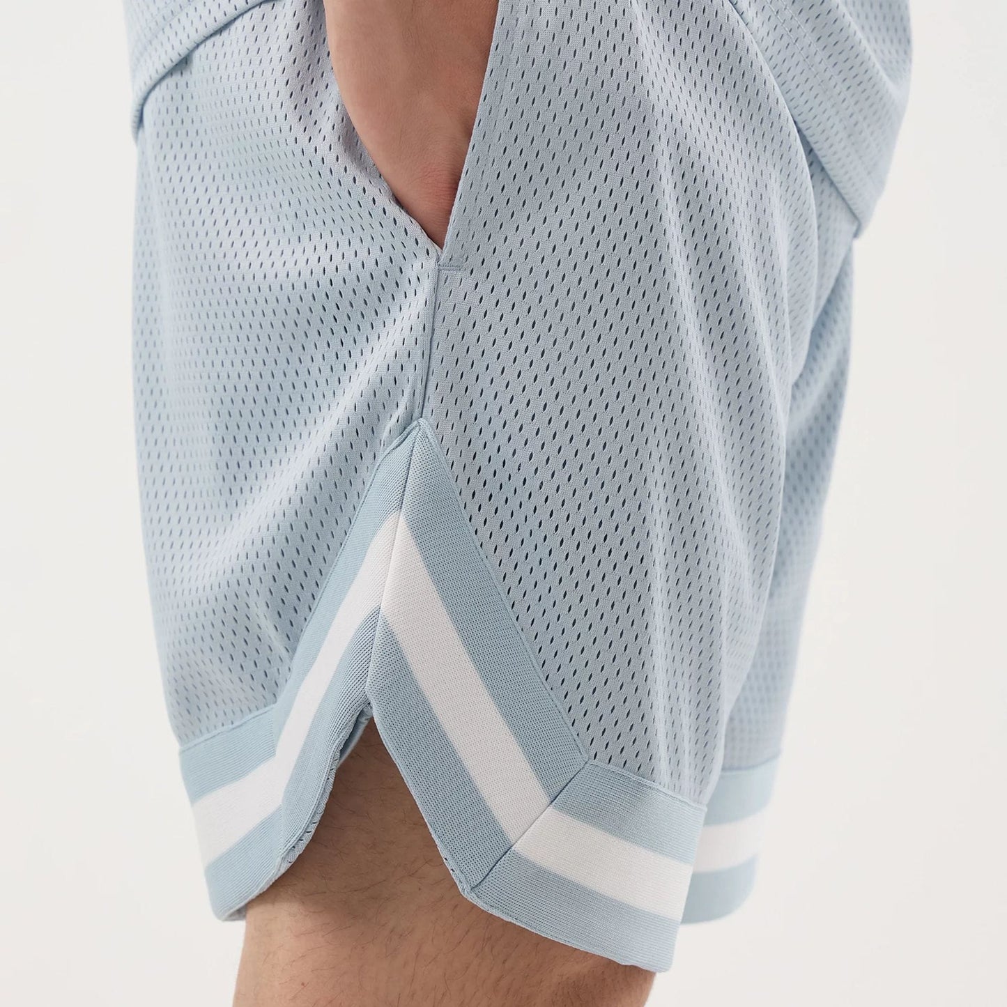 The model is wearing this New Era Mesh Oversized Shorts in pastel blue. 4