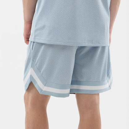 The model is wearing this New Era Mesh Oversized Shorts in pastel blue. 7