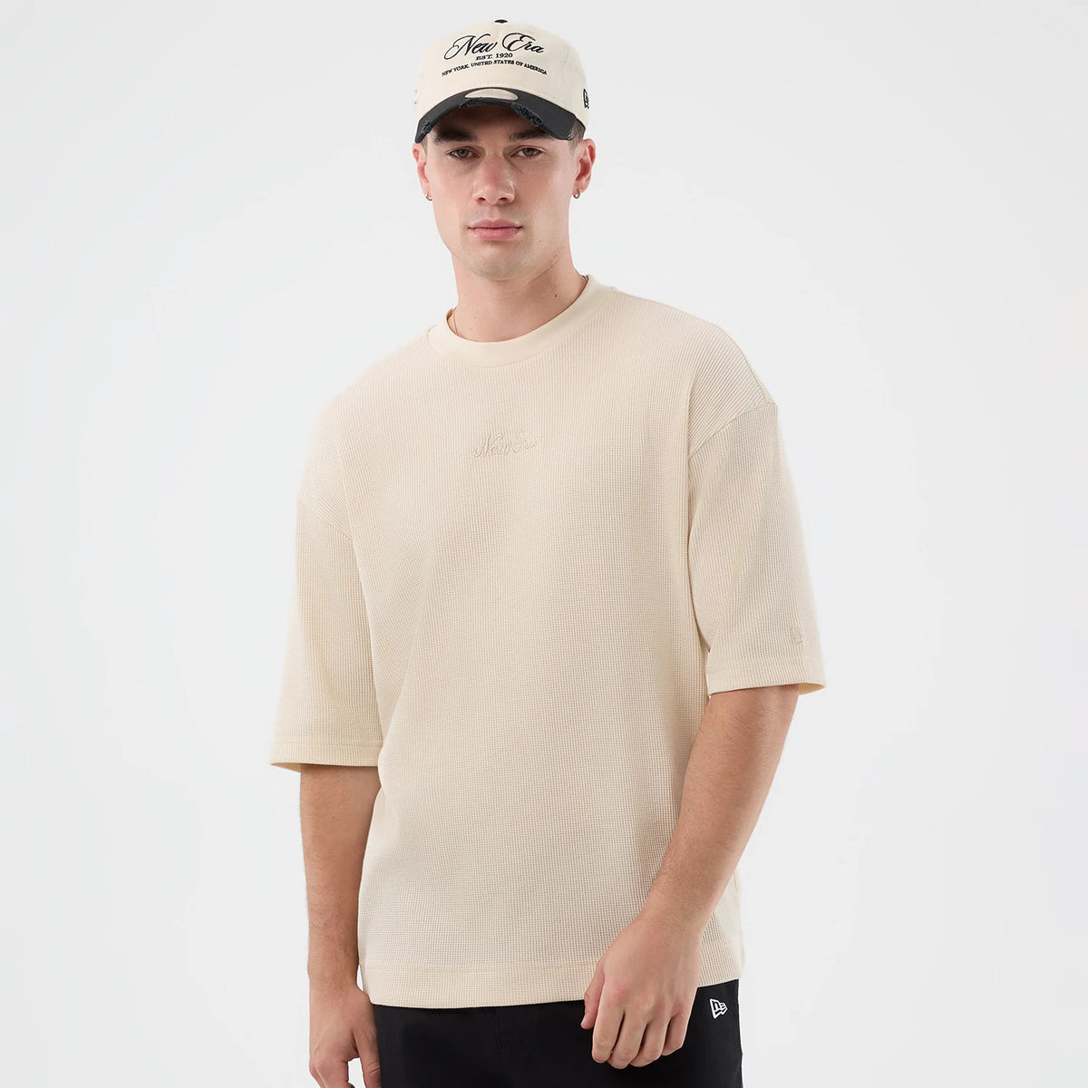 The model is wearing this New Era Waffle T-Shirt in light beige. 3