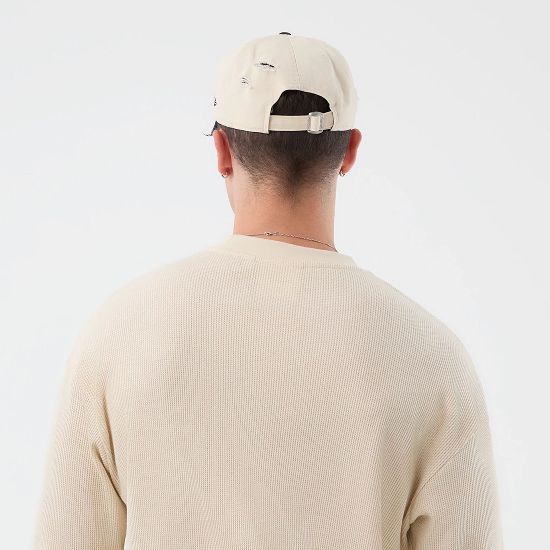 The model is wearing this New Era Waffle T-Shirt in light beige. 8