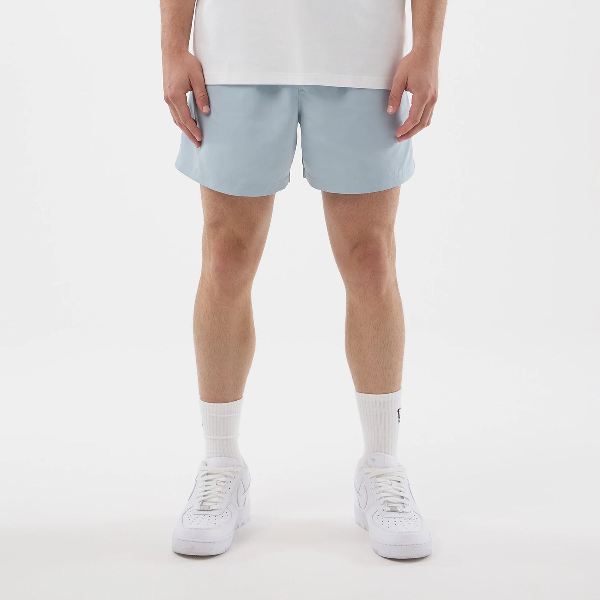 The model is wearing this New Era Swimming Shorts in pastel blue. 1