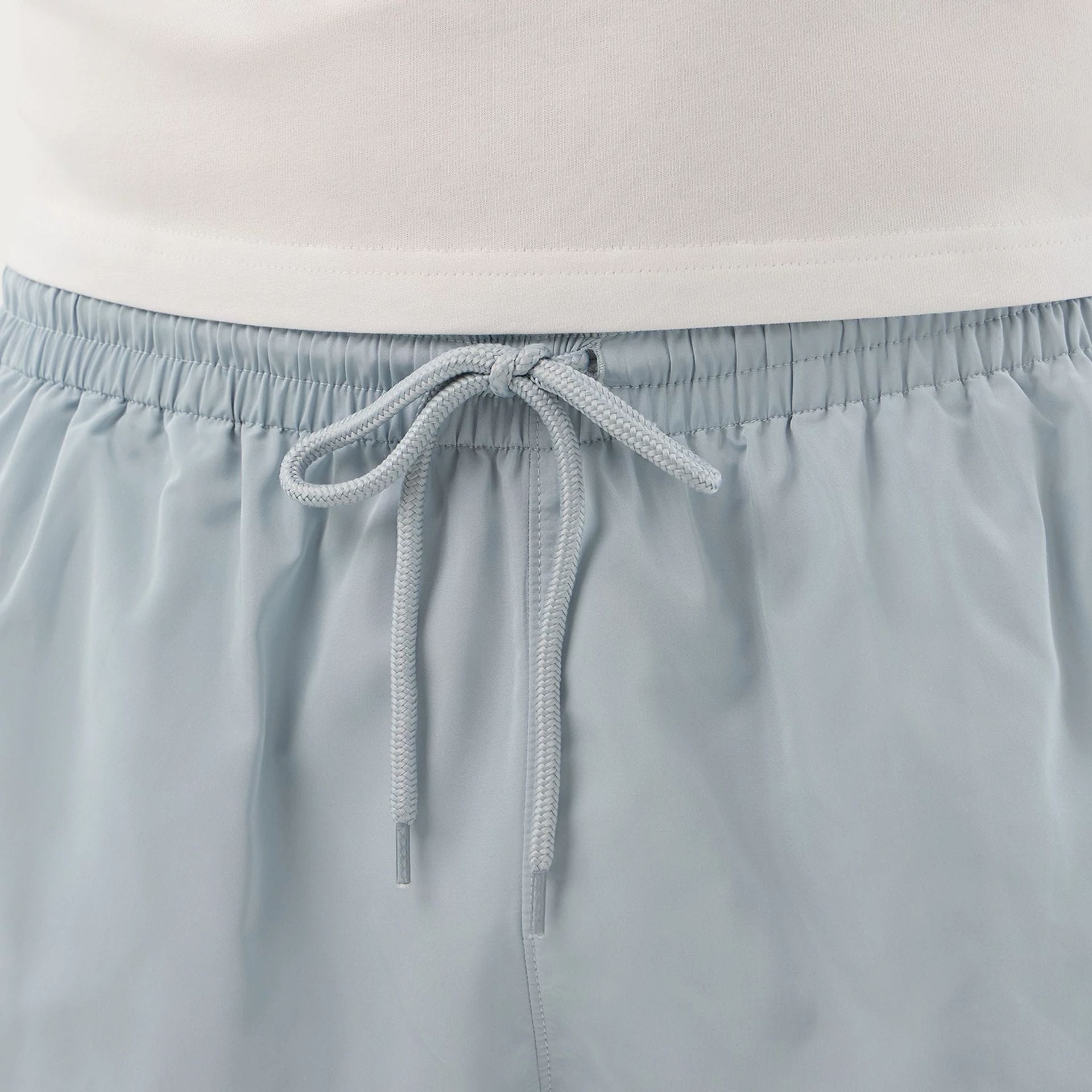 The model is wearing this New Era Swimming Shorts in pastel blue. 7