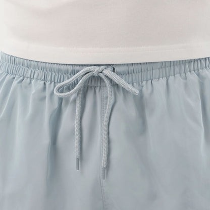 The model is wearing this New Era Swimming Shorts in pastel blue. 7