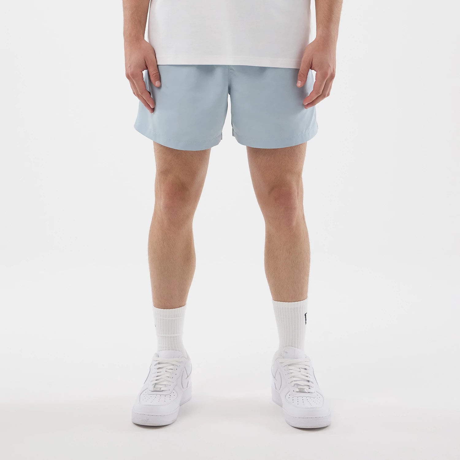 The model is wearing this New Era Swimming Shorts in pastel blue. 1