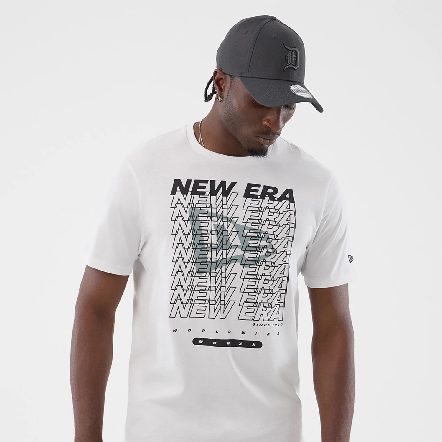 The model is wearing this New Era Logo Graphic T-Shirt in white. 3
